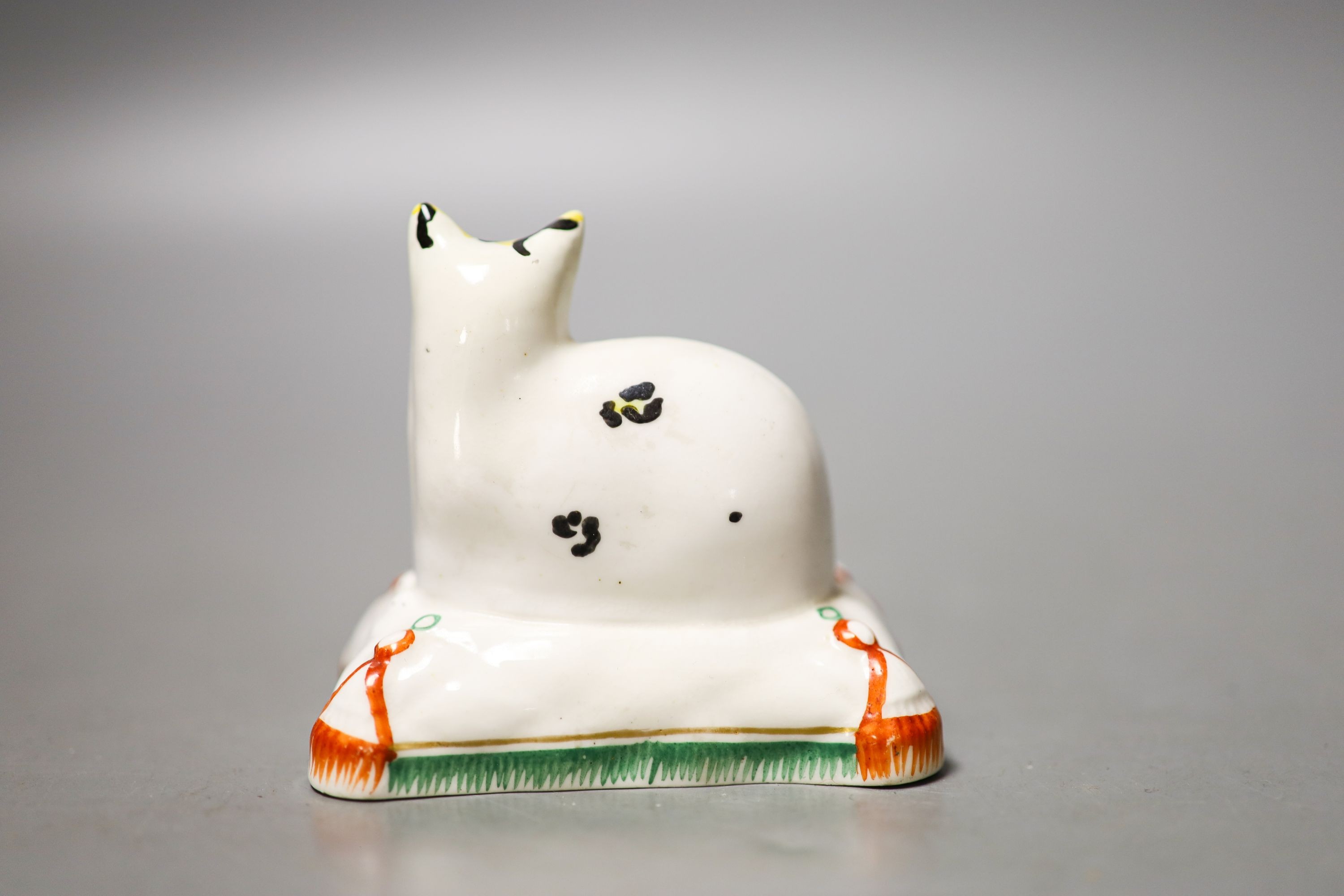 A Staffordshire porcelain model of a cat seated on a cushion, c.1835–50